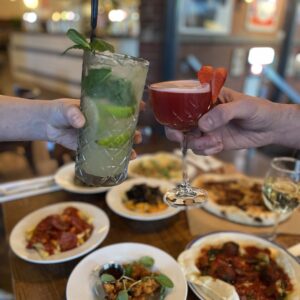 Food offers. Friends sharing main meals at Forum Sheffield restaurant, enjoying 50% off dining offer in October.