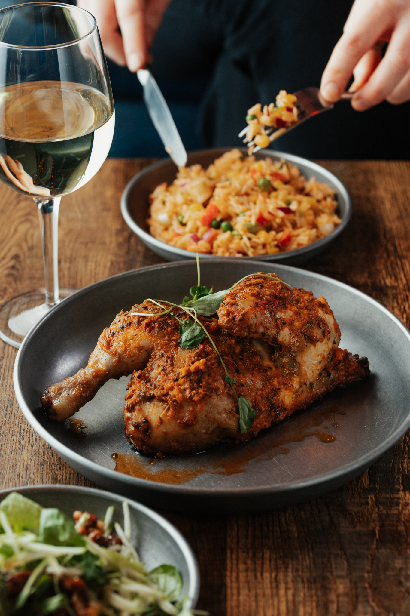 Half a piri-piri chicken with dirty rice and a glass of white wine at Forum Kitchen + Bar